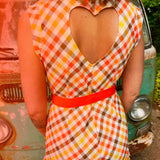 girl in 1970s Gingham Belted Romper in front of green VW vintage bus