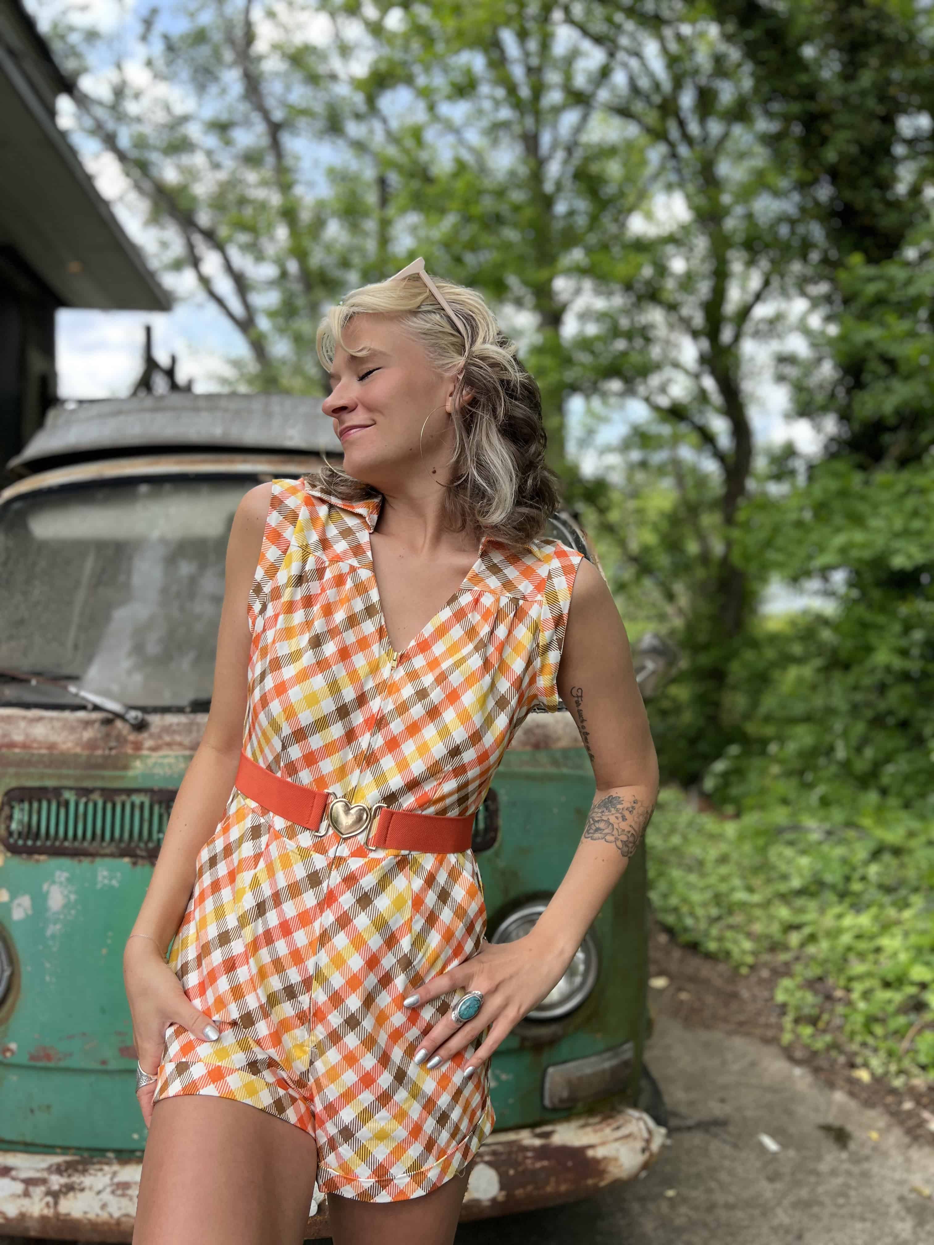 girl in 1970s Gingham Belted Romper in front of green VW vintage bus