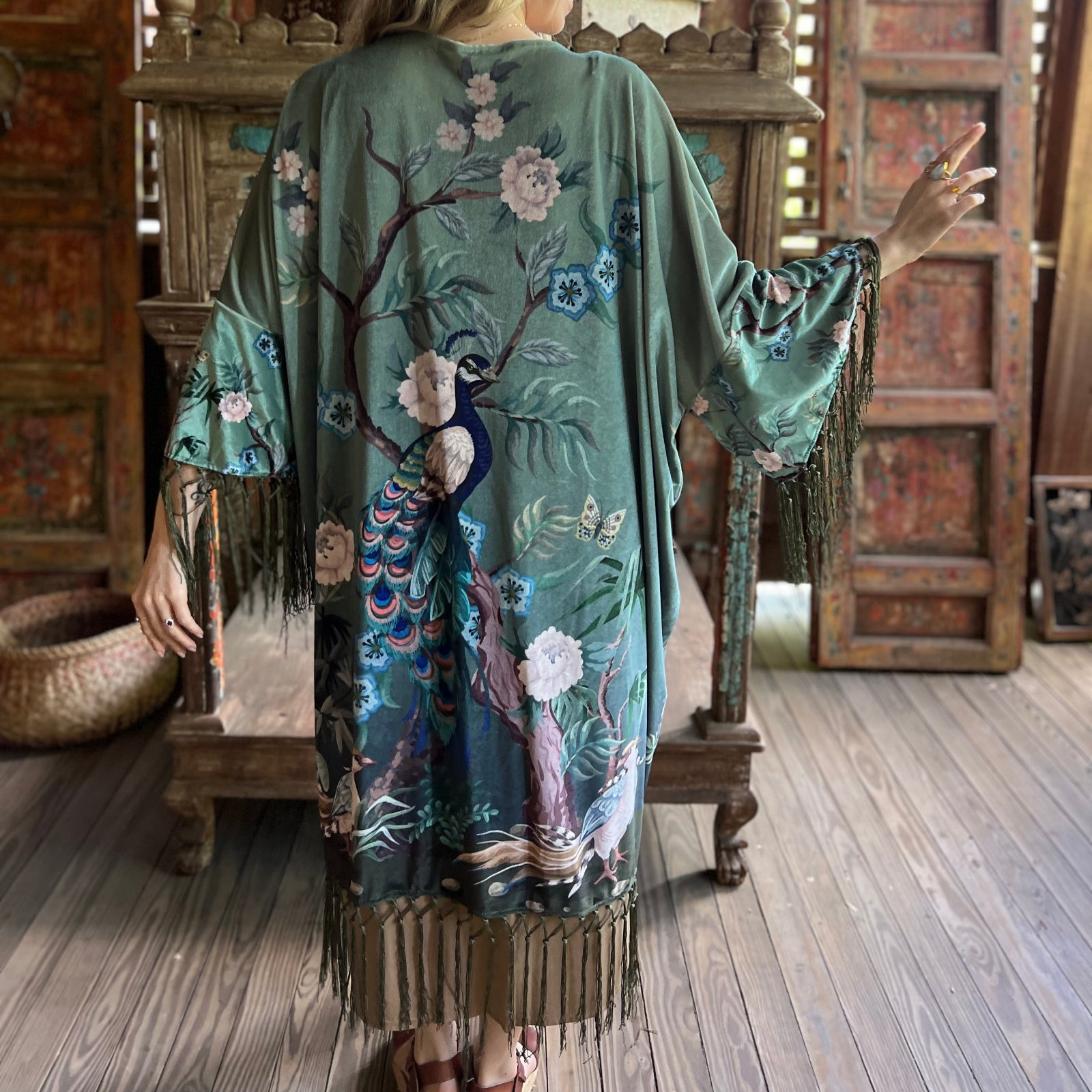 Someone wearing the 1930s Vintage Teal Peacock Fringe Kimono.