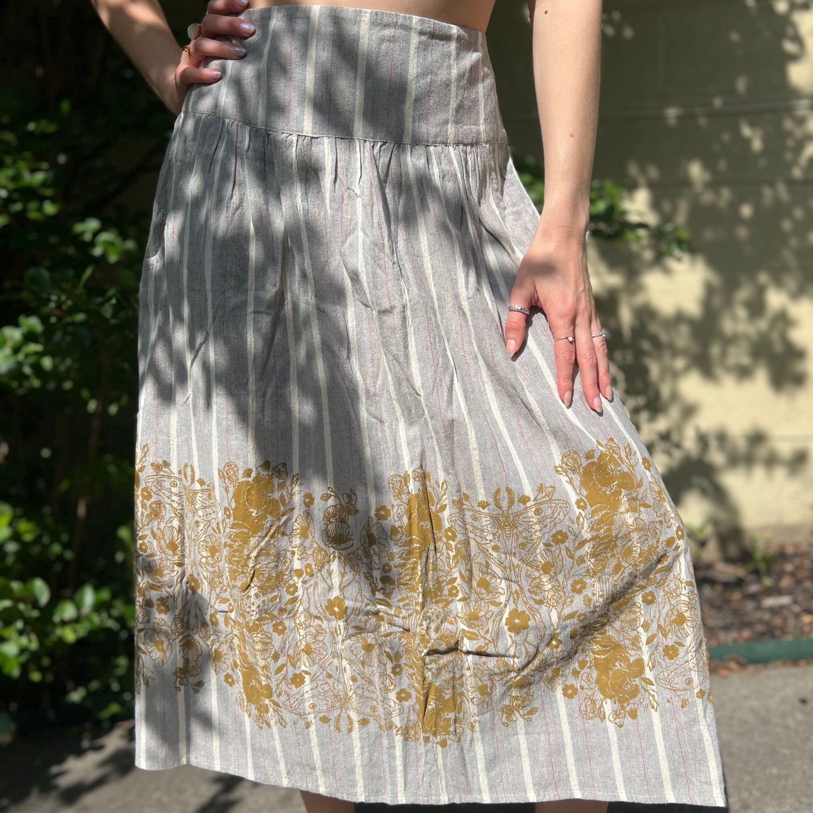 Someone wearing the gray Midnight Floral Midi Skirt.