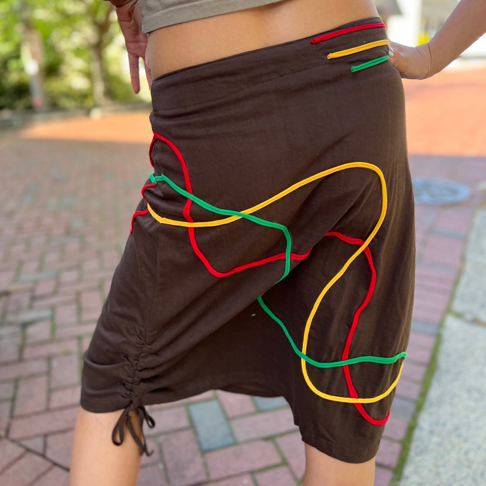 Someone wearing the Sinker Skirt with Rasta Piping.