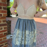 Someone wearing the Midnight Floral Crochet Halter Dress.