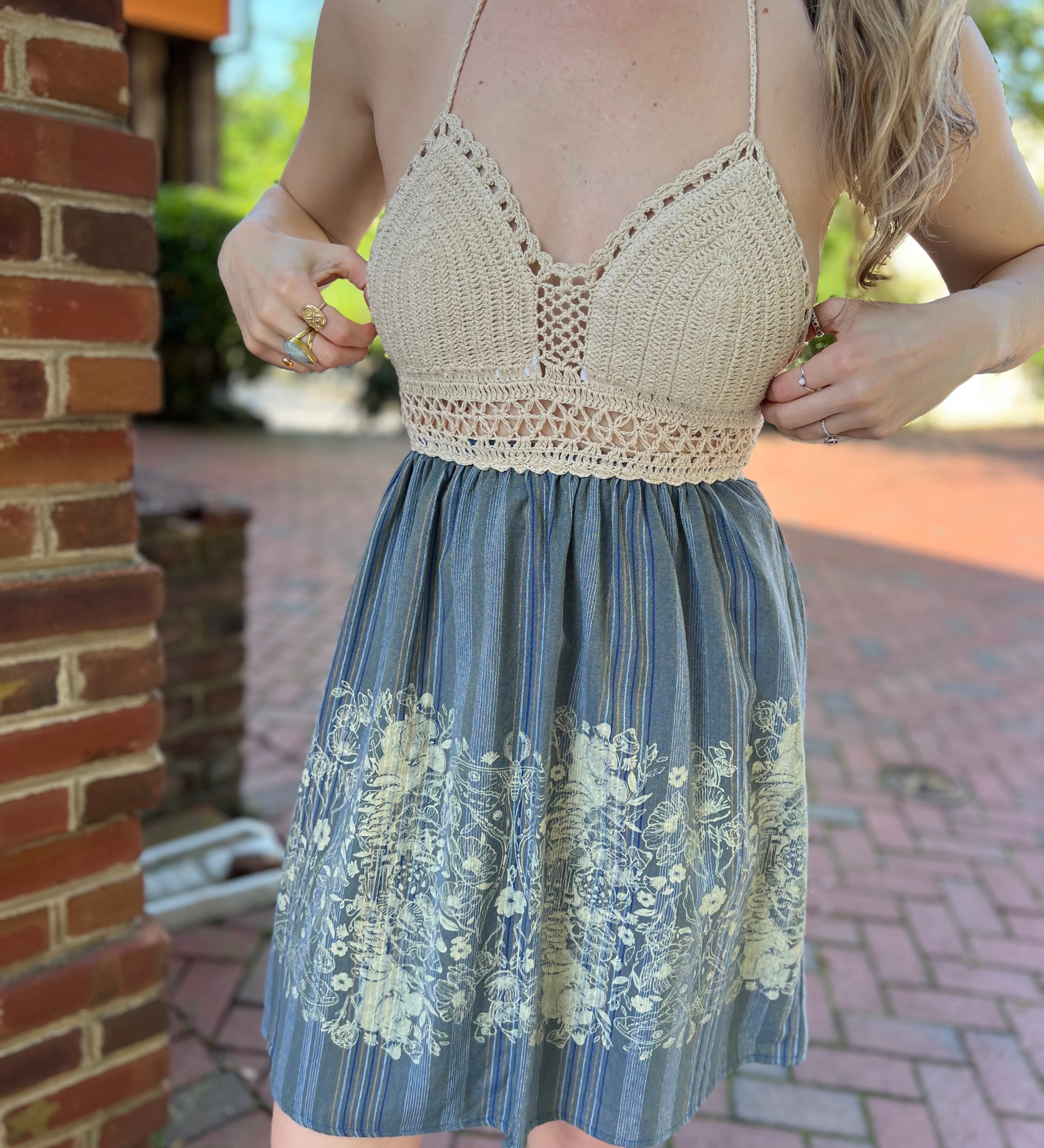 Someone wearing the Midnight Floral Crochet Halter Dress.