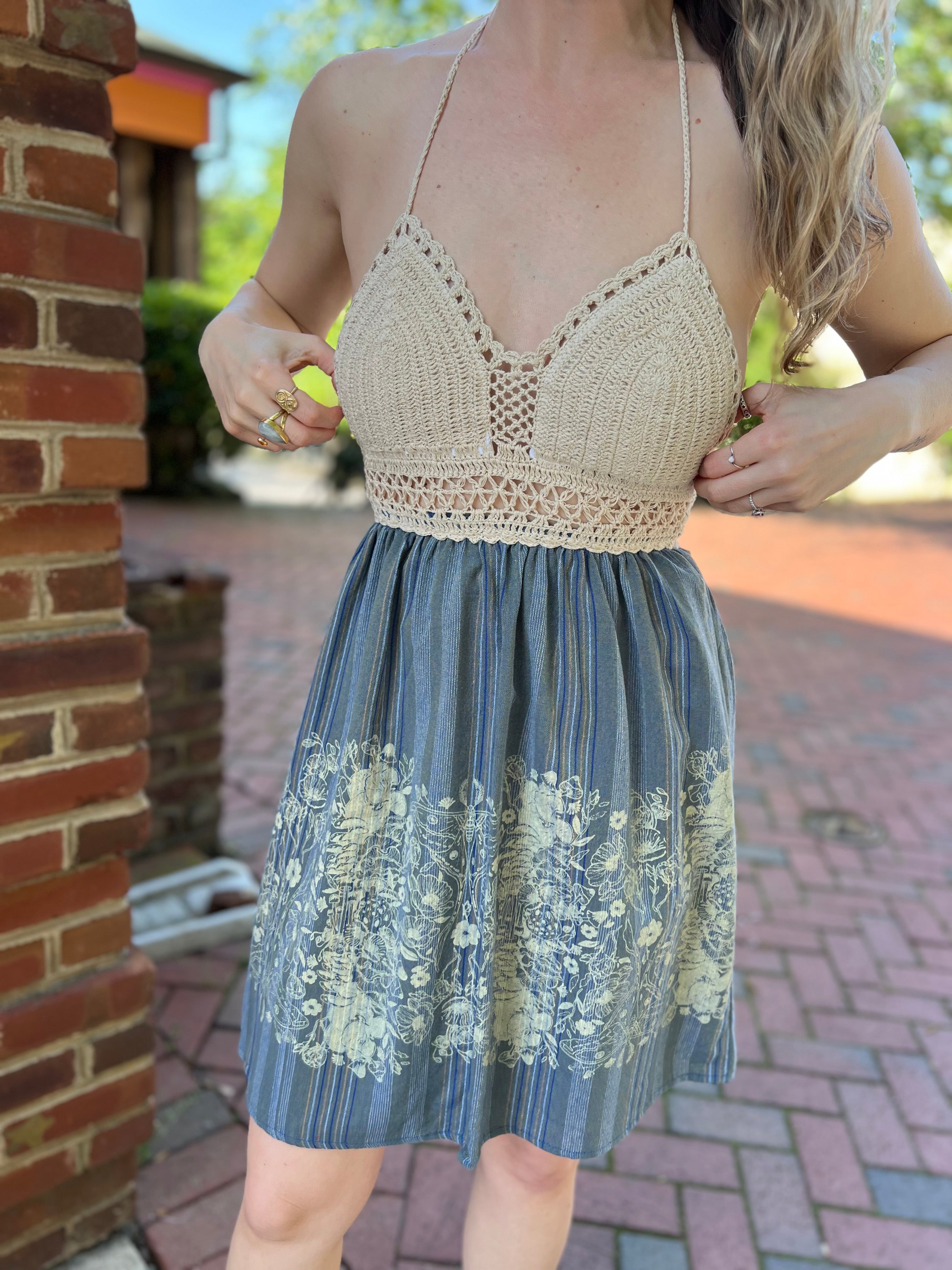 Someone wearing the Midnight Floral Crochet Halter Dress.