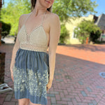 Someone wearing the Midnight Floral Crochet Halter Dress.