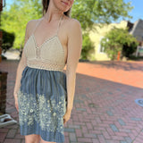 Someone wearing the Midnight Floral Crochet Halter Dress.