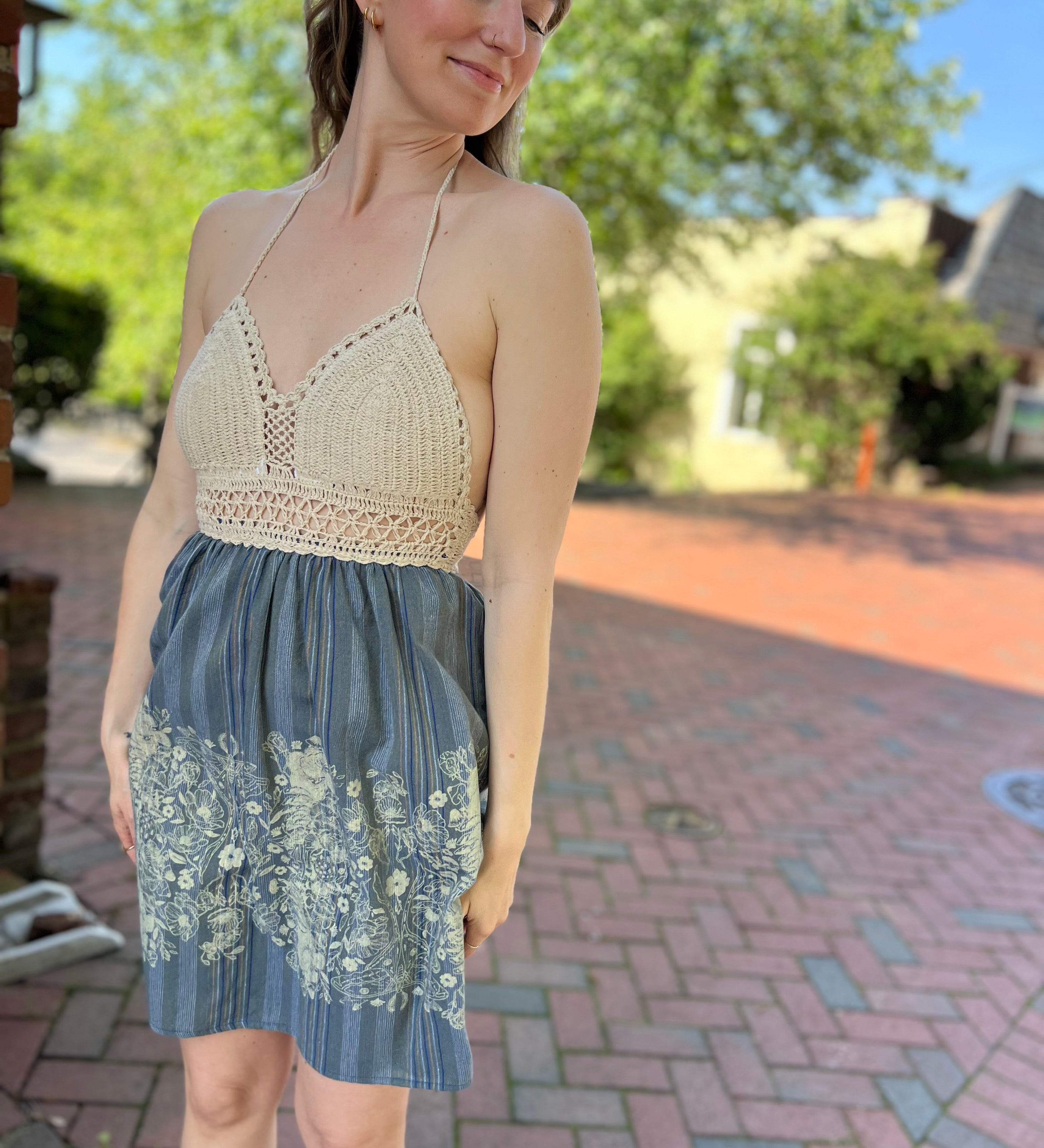 Someone wearing the Midnight Floral Crochet Halter Dress.