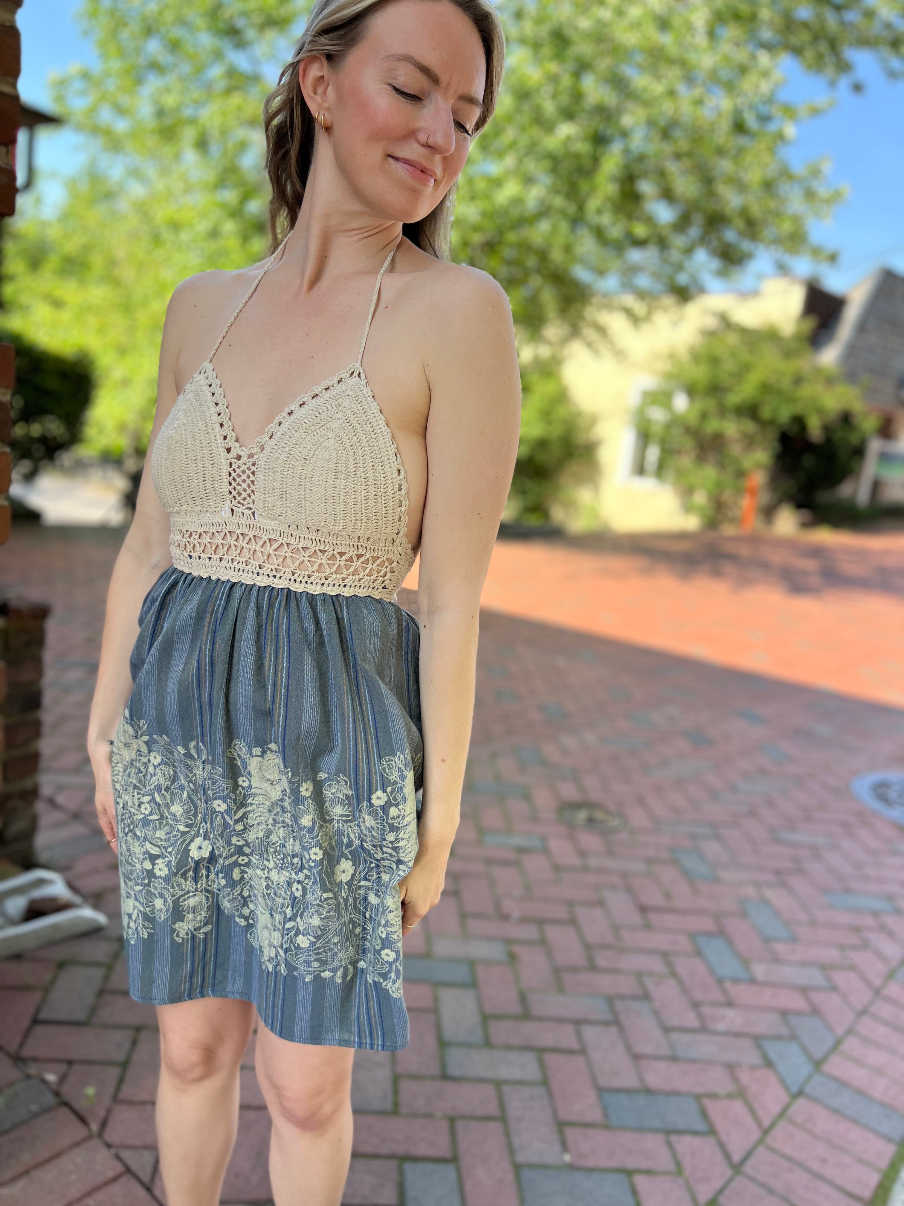 Someone wearing the Midnight Floral Crochet Halter Dress.