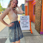 Someone wearing the Midnight Floral Crochet Halter Dress.
