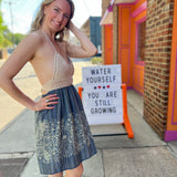 Someone wearing the Midnight Floral Crochet Halter Dress.