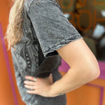 A woman wearing the Gray Mandala Stonewashed Cotton T-shirt with jeans in front an orange and pink wall.