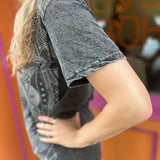 A woman wearing the Gray Mandala Stonewashed Cotton T-shirt with jeans in front an orange and pink wall.