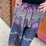 A woman wearing the Purple Floral Cotton Trousers.