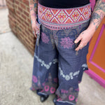 A woman wearing the Purple Floral Cotton Trousers.