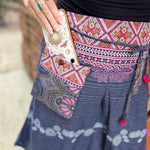 A woman wearing the Purple Floral Cotton Trousers.