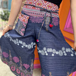 A woman wearing the Purple Floral Cotton Trousers.