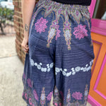 A woman wearing the Purple Floral Cotton Trousers.