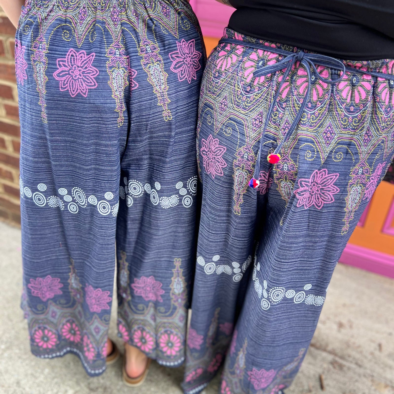 Two women wearing the Purple Floral Cotton Trousers.