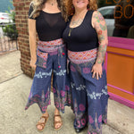 Two women wearing the Purple Floral Cotton Trousers.