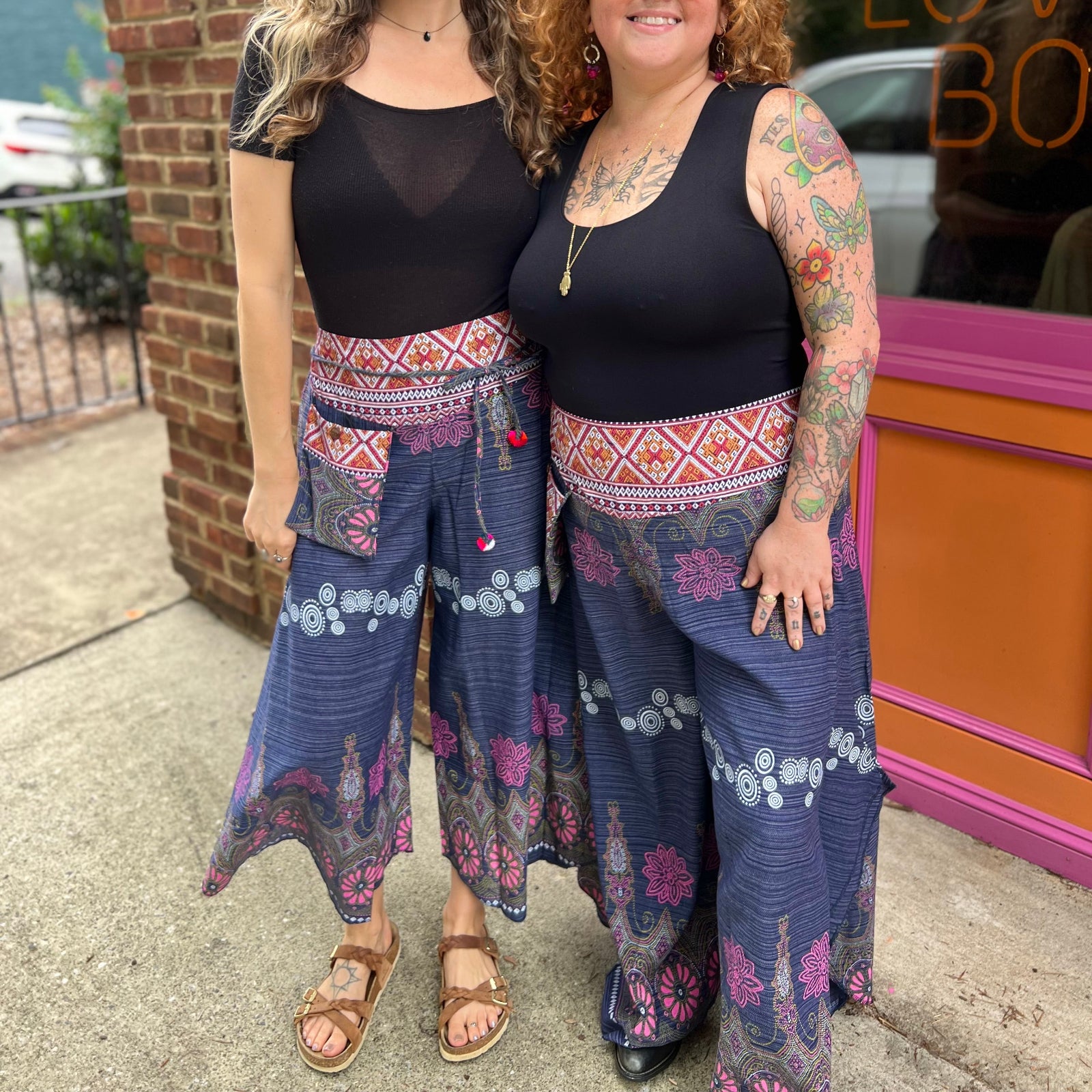 Two women wearing the Purple Floral Cotton Trousers.