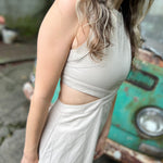 A woman wearing the cream Solid Linen Cut-Out Midi Dress in front of a vintage teal Volkswagen bus.