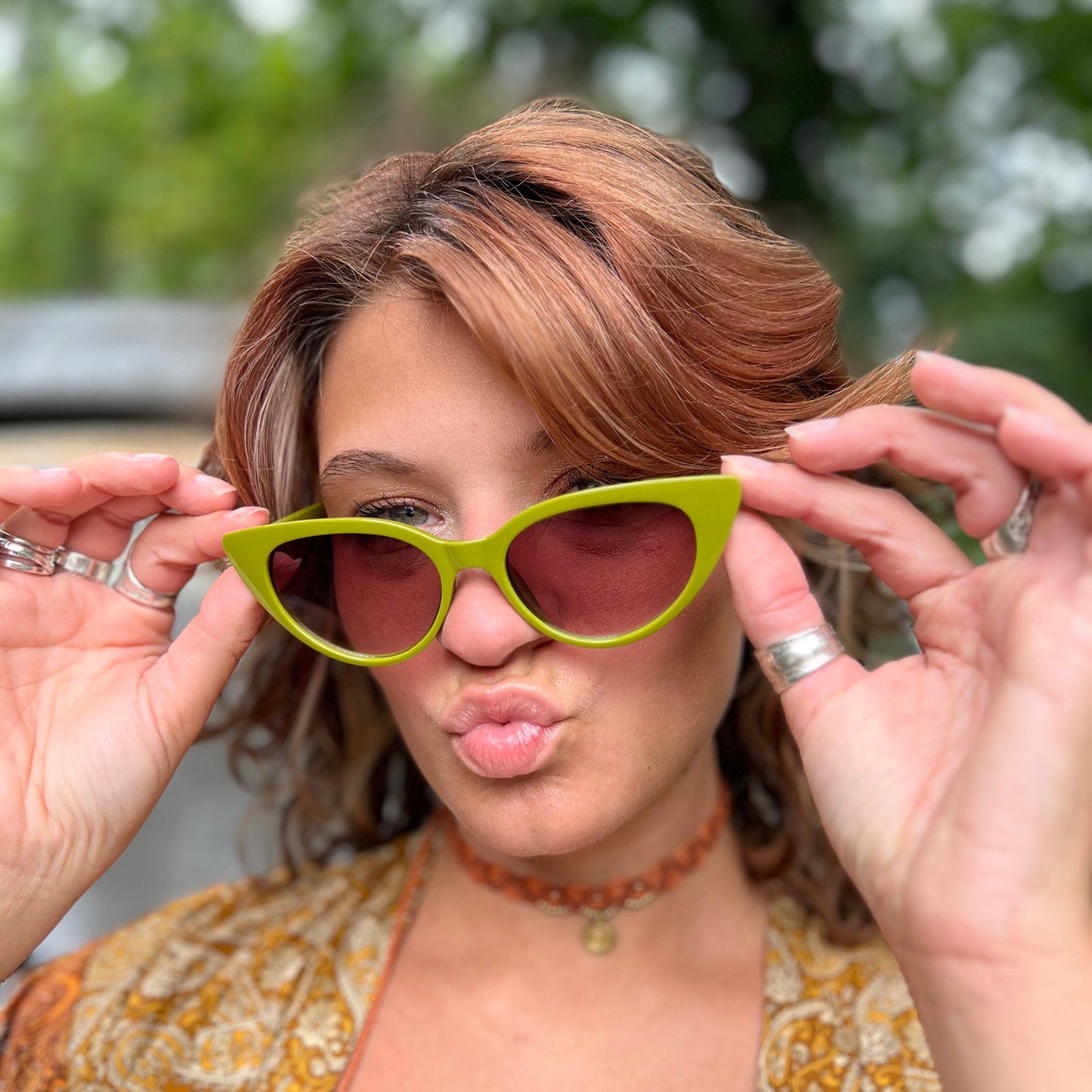 Someone wearing the Frenchie Seventies Cat-Eye Sunglasses with an orange patterned kimono.