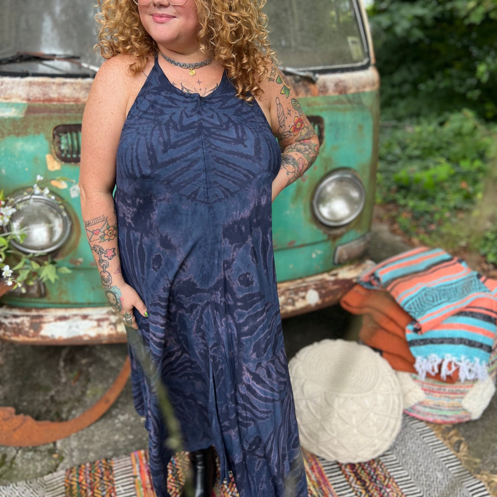 A woman wearing the spellbound Hippie Boho Maxi Flowy Tie Dye Dress in front of a vintage Volkswagen Bus.