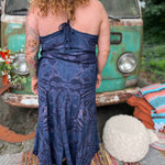 A woman wearing the spellbound Hippie Boho Maxi Flowy Tie Dye Dress in front of a vintage Volkswagen Bus.