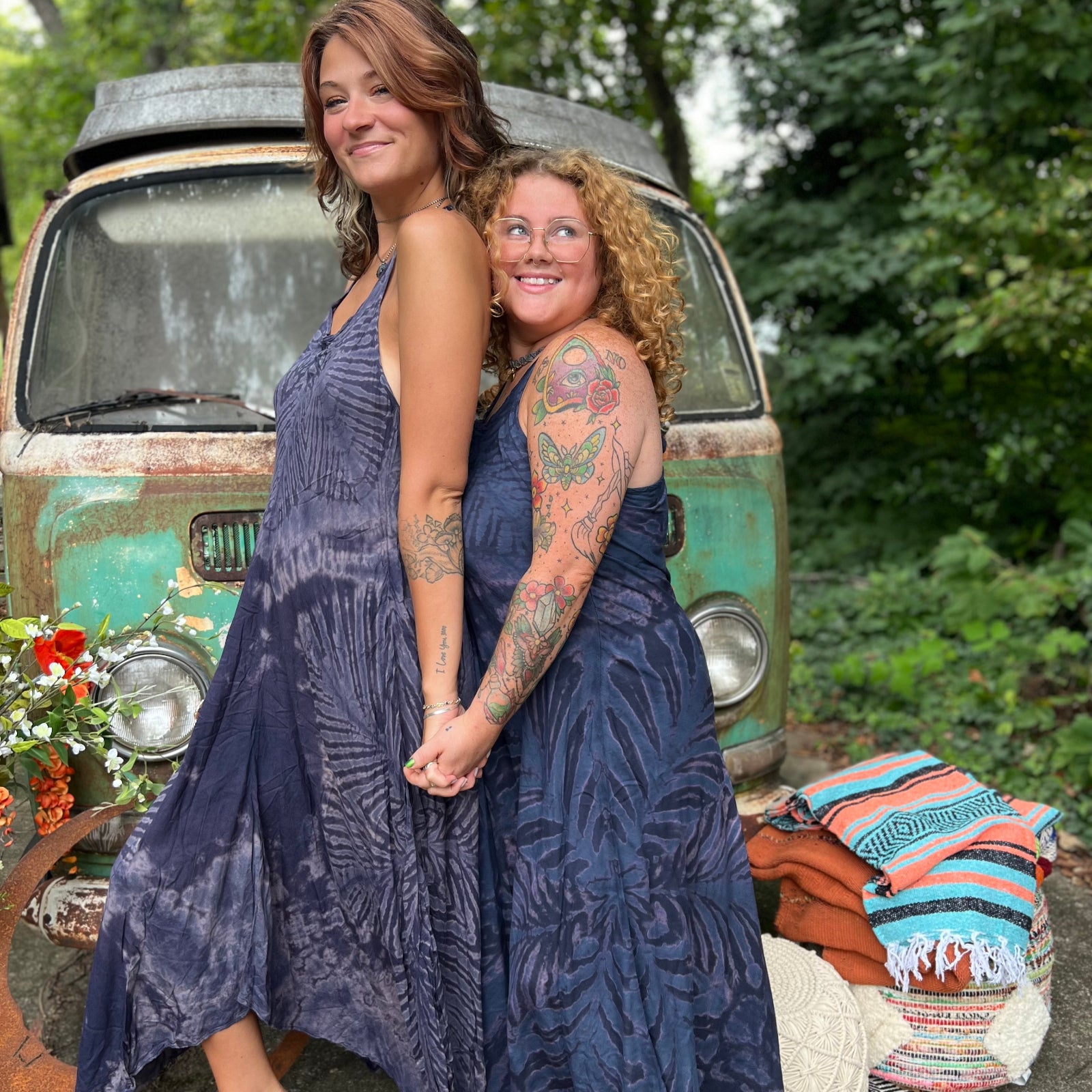 Two women wearing the spellbound Hippie Boho Maxi Flowy Tie Dye Dress in front of a vintage Volkswagen Bus.