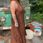 A woman wearing the amber gold Hippie Boho Maxi Flowy Tie Dye Dress in front of a vintage Volkswagen Bus.
