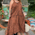 A woman wearing the amber gold Hippie Boho Maxi Flowy Tie Dye Dress in front of a vintage Volkswagen Bus.