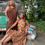 Two women wearing the amber gold Hippie Boho Maxi Flowy Tie Dye Dress in front of a vintage Volkswagen Bus.