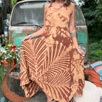 A woman wearing the amber gold Hippie Boho Maxi Flowy Tie Dye Dress in front of a vintage Volkswagen Bus.