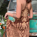 A woman wearing the amber gold Hippie Boho Maxi Flowy Tie Dye Dress in front of a vintage Volkswagen Bus.