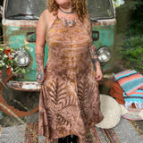 A woman wearing the moondance mauve gold Hippie Boho Maxi Flowy Tie Dye Dress in front of a vintage Volkswagen Bus.