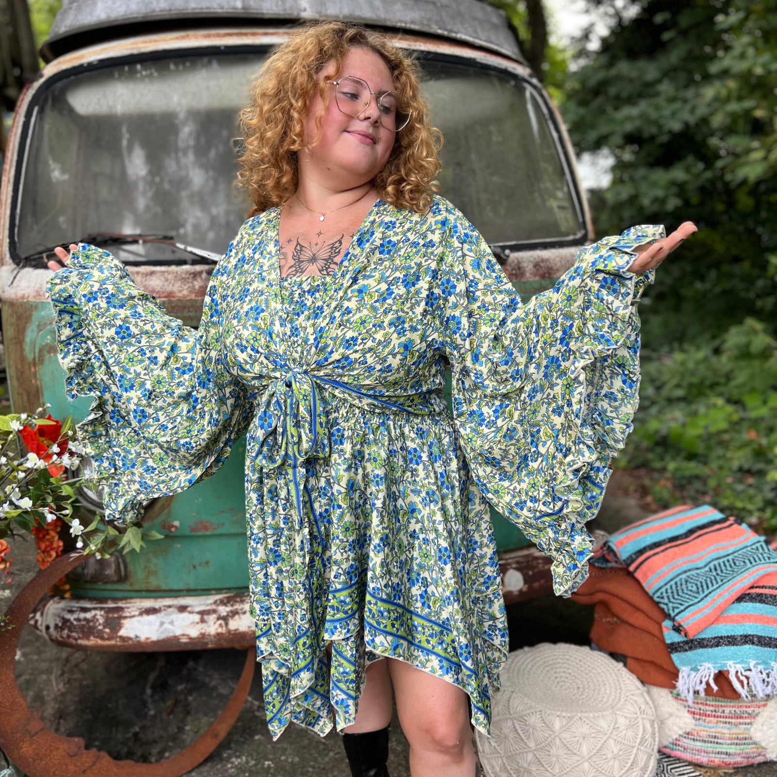 A woman wearing the green Hippie Bohemian Fairy Dress with Elastic Fairy Skirt in front of a vintage Volkswagen bus.