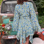 A woman wearing the green Hippie Bohemian Fairy Dress with Elastic Fairy Skirt in front of a vintage Volkswagen bus.