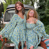 Two women wearing the green Hippie Bohemian Fairy Dress with Elastic Fairy Skirt in front of a vintage Volkswagen bus.