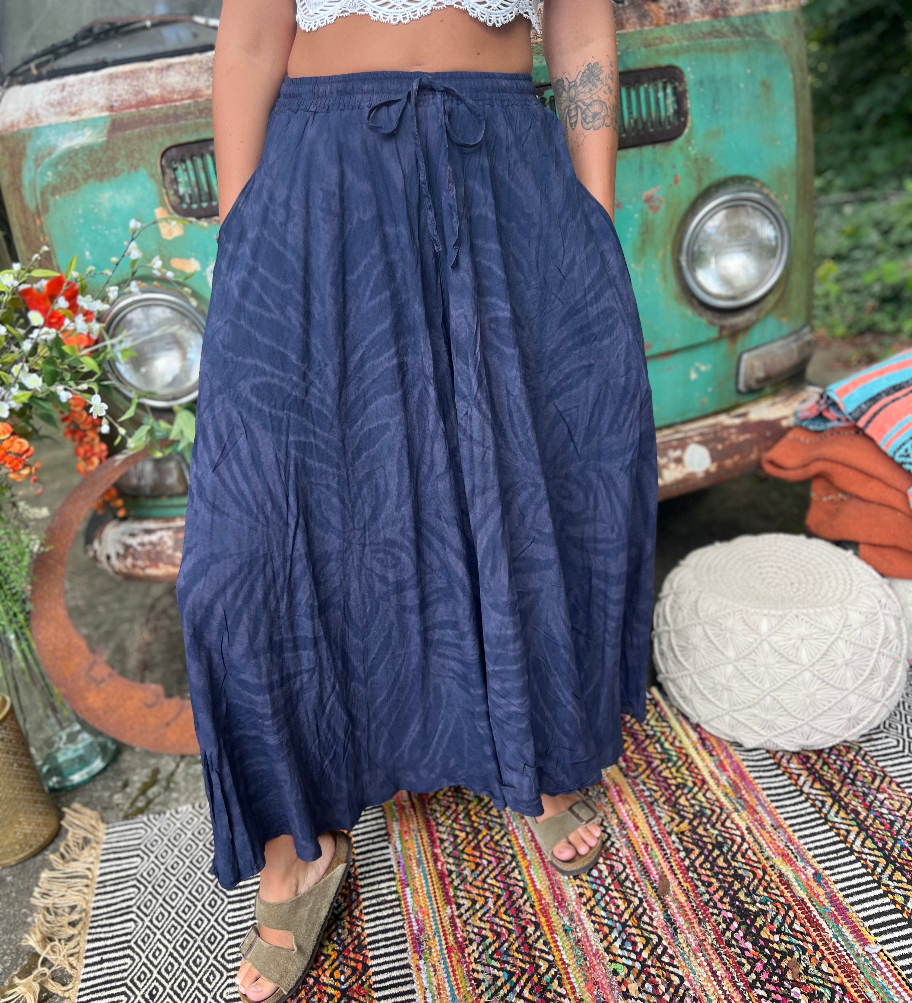 A woman wearing the navy Hippie Bohemian Hand Dyed Palazzo Pants in front of a vintage Volkswagen bus.