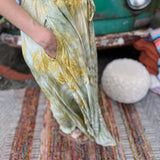 A woman wearing the green Hippie Bohemian Hand Dyed Palazzo Pants in front of a vintage Volkswagen bus.