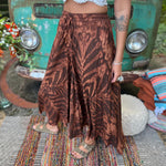 A woman wearing the brown Hippie Bohemian Hand Dyed Palazzo Pants in front of a vintage Volkswagen bus.