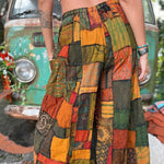 A woman wearing the Bohemian Patchwork Flare Wide Leg Pants in front of a vintage Volkswagen bus.