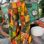 A woman wearing the Bohemian Patchwork Flare Wide Leg Pants in front of a vintage Volkswagen bus.