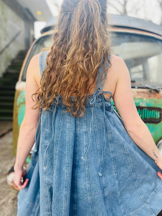 close up of boho chic denim dress styled in front of a VW bus