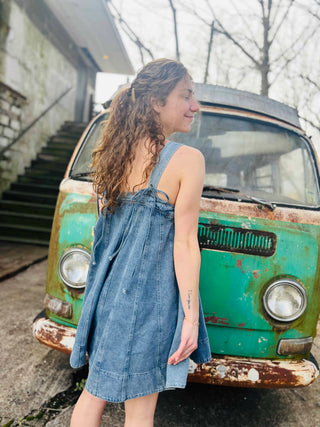 denim dress with girl with hair pulled back in front of retro background