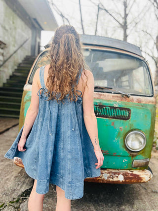 retro look with free spirited styled hair and mini denim dress