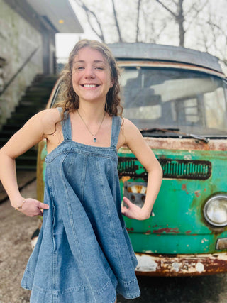 denim dress on cute girl with boho styled background with VW bus