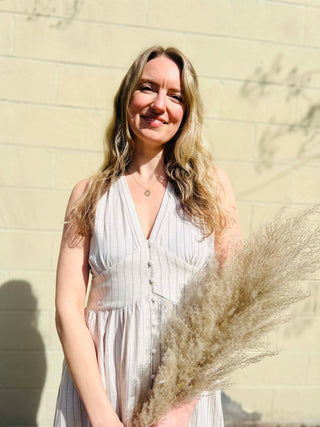 close up view of top of linen maxi dress with pampas grass 