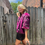 A woman wearing the Faux Fur Jacket in Monster Pink by Jennafer Grace with a black dress.