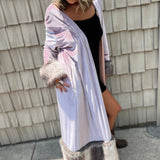A woman wearing the Blush Velvet Faux Fur Jacket by Jennafer Grace with a black dress and brown boots.